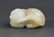 A WHITE JADE PENDANT FIGURE OF "RUI SHOU"