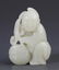 A FINELY CARVED HETIAN GREENISH WHITE JADE