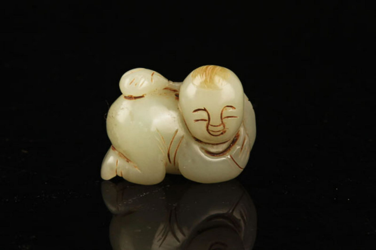 A FINE HETIAN JADE IN FIGURE OF BOY PLAYING (1 of 4)