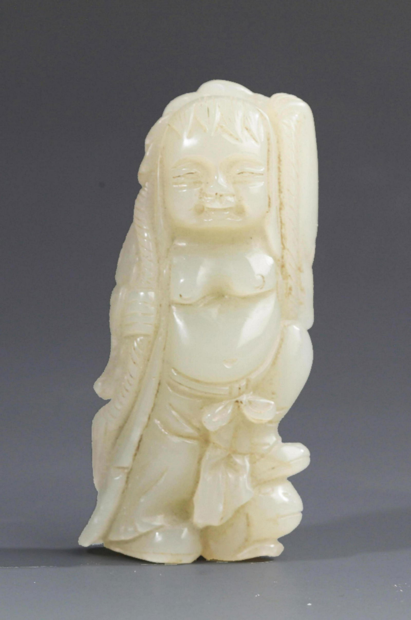 A GREENISH WHITE JADE DECORATION IN FIGURE OF DEITY (1 of 2)