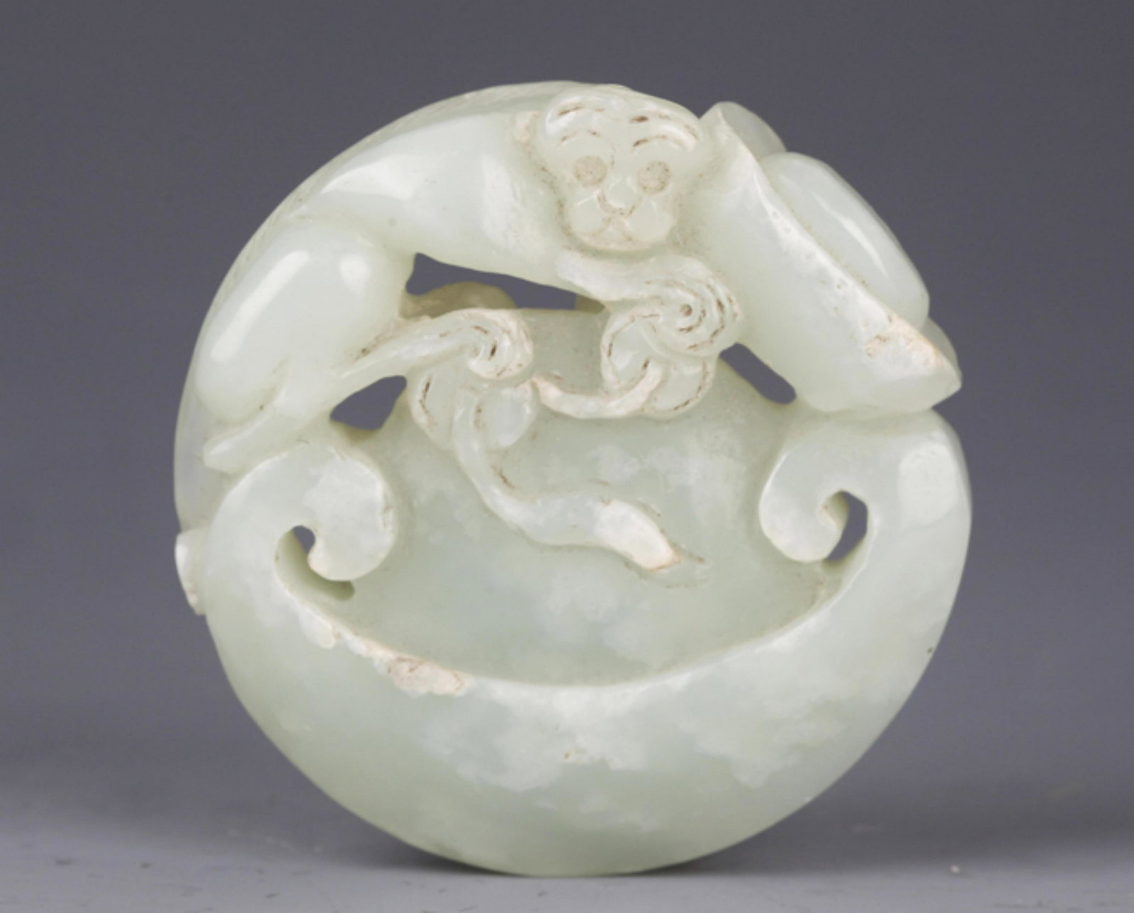 A FINE PALE CELADON JADE IN FIGURE OF MONKEY: Republic Period, Diameter: 2.2 inch