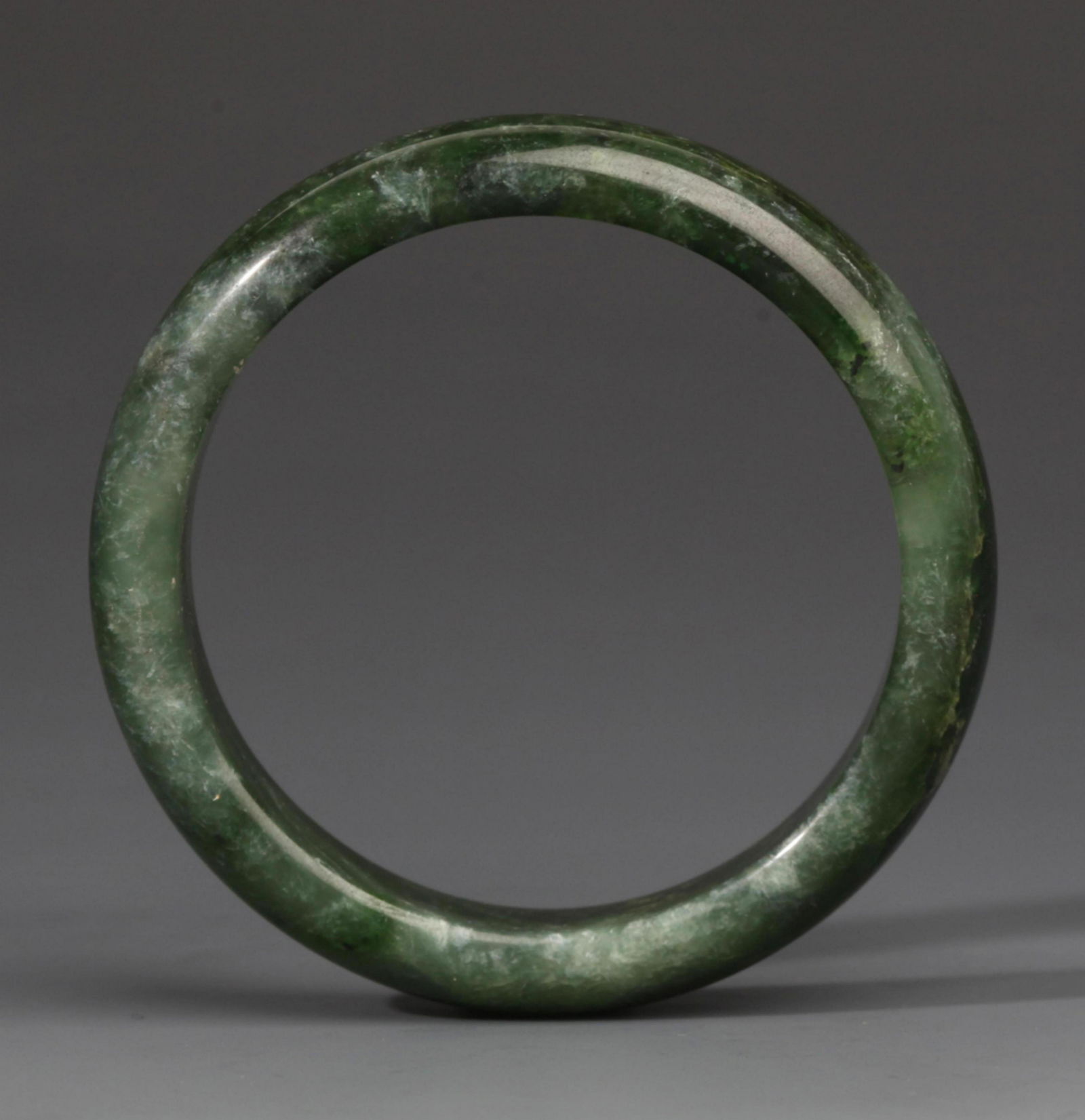 A FINE HETIAN GREEN JADE BANGLE (1 of 2)