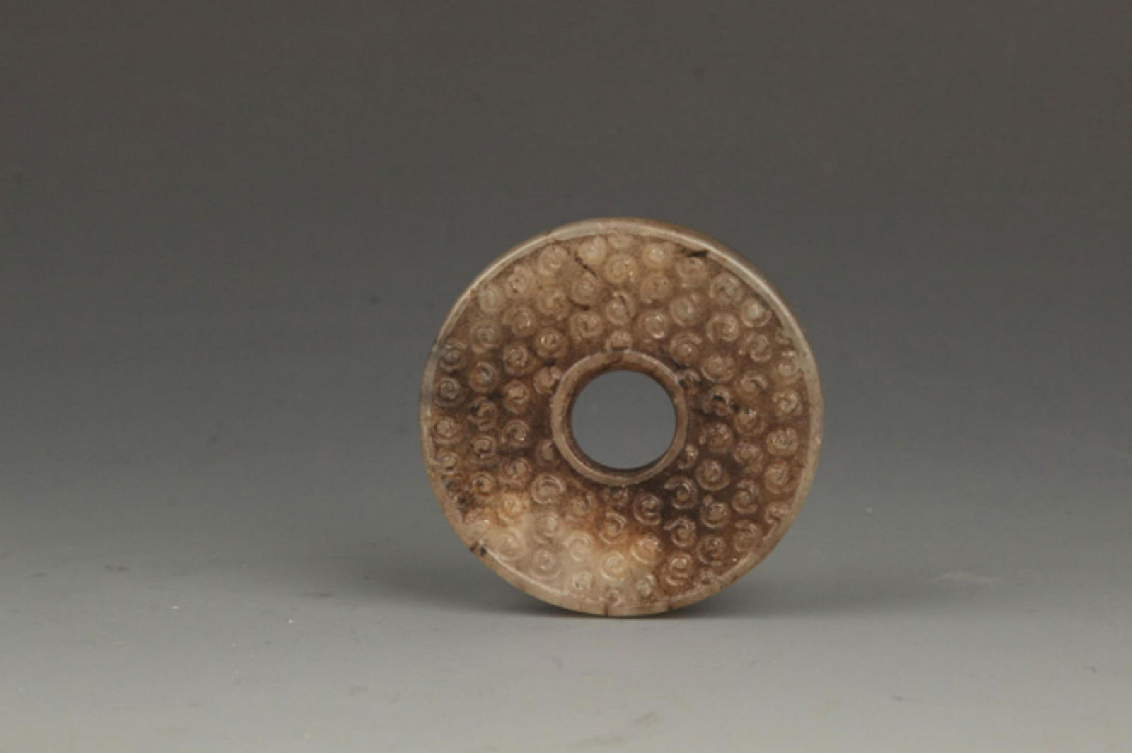 AN OLD ROUND JADE (1 of 3)