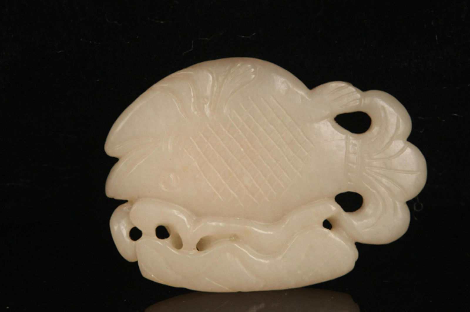 A FINE PALE CELADON JADE IN FIGURE OF FISH (1 of 3)