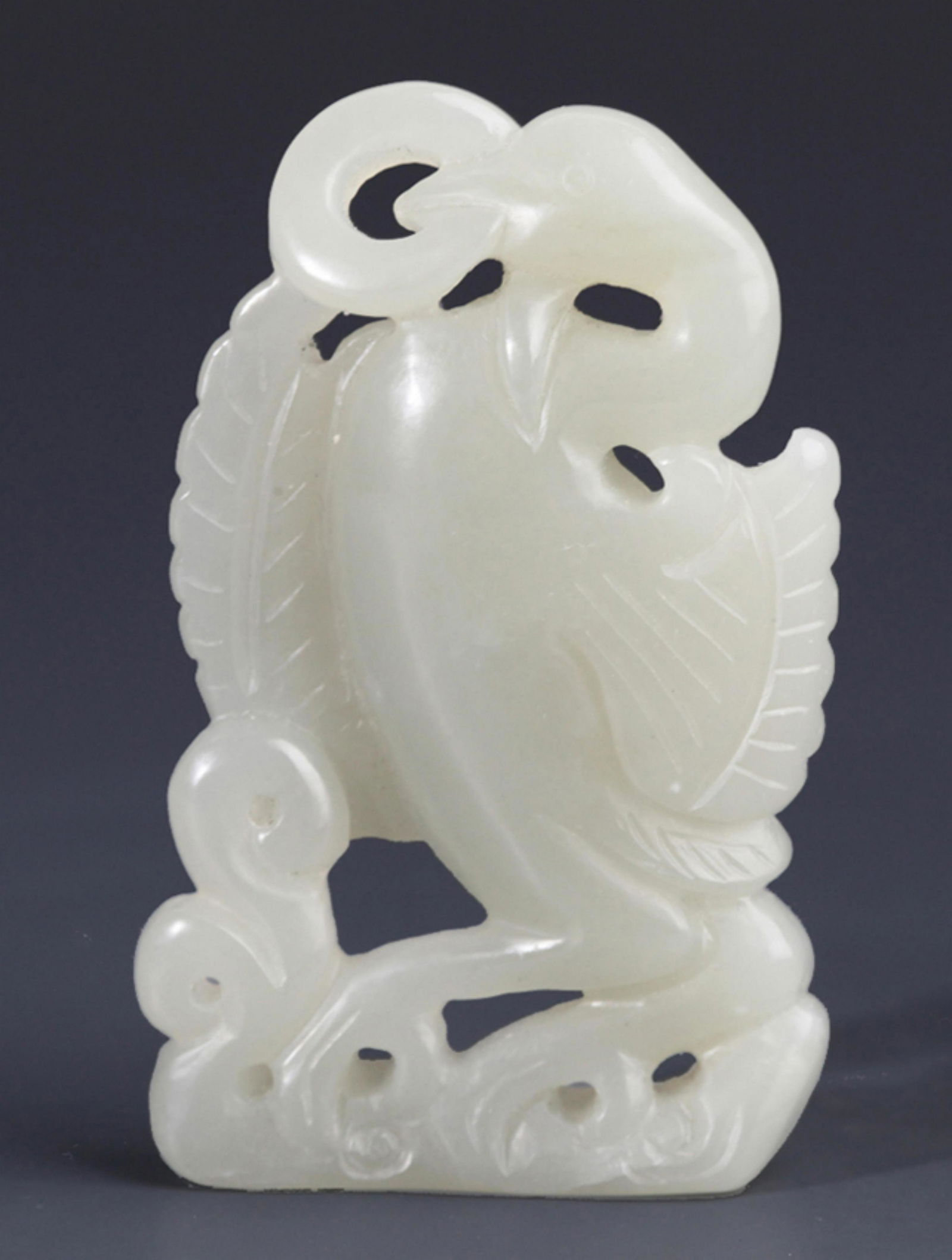 A FINELY CARVED RUI NIAO PALE CELADON JADE PENDANT: Republic Period; Width: 1.38 inch; High: 2.36 inch