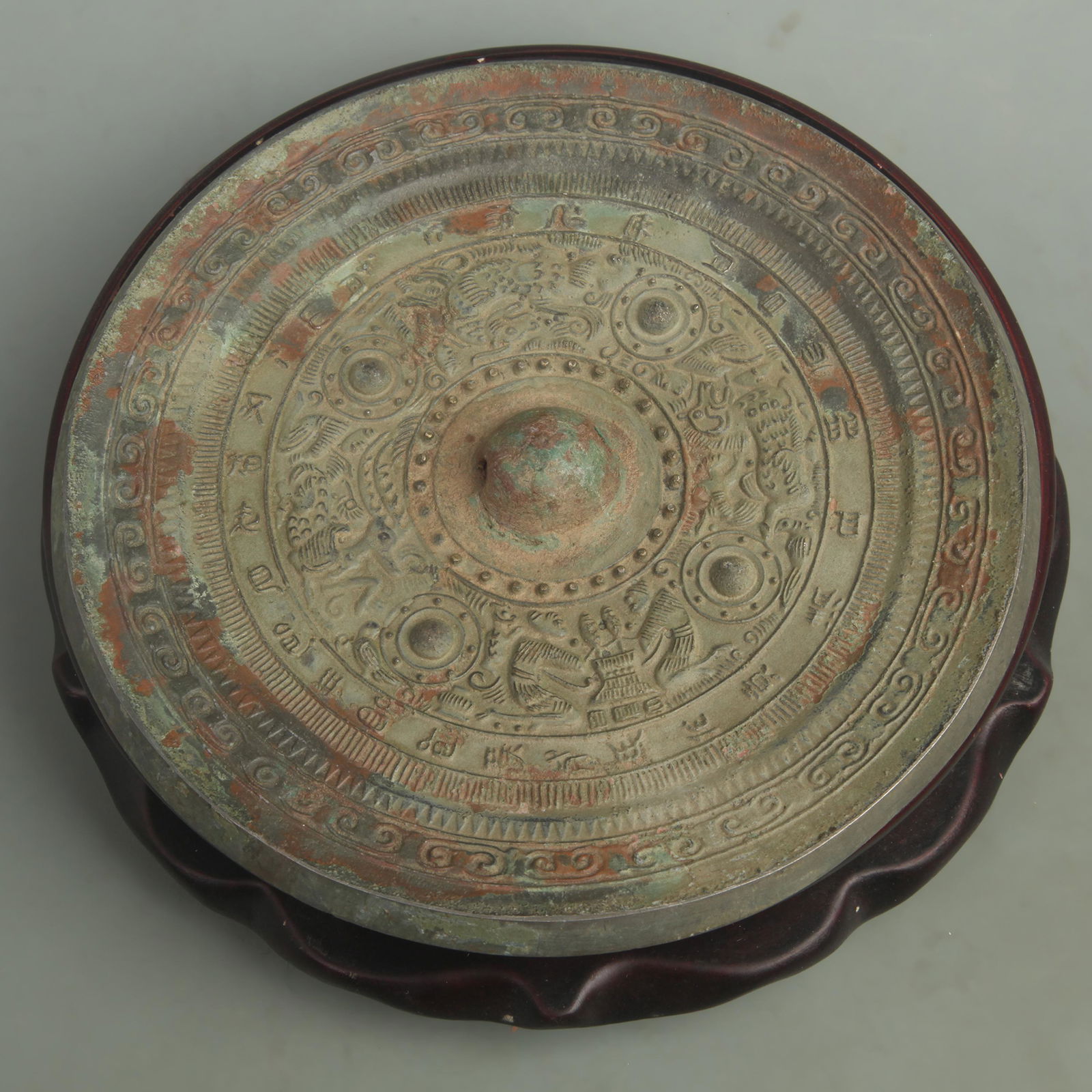 A FINELY CARVED BRONZE MIRROR (1 of 4)