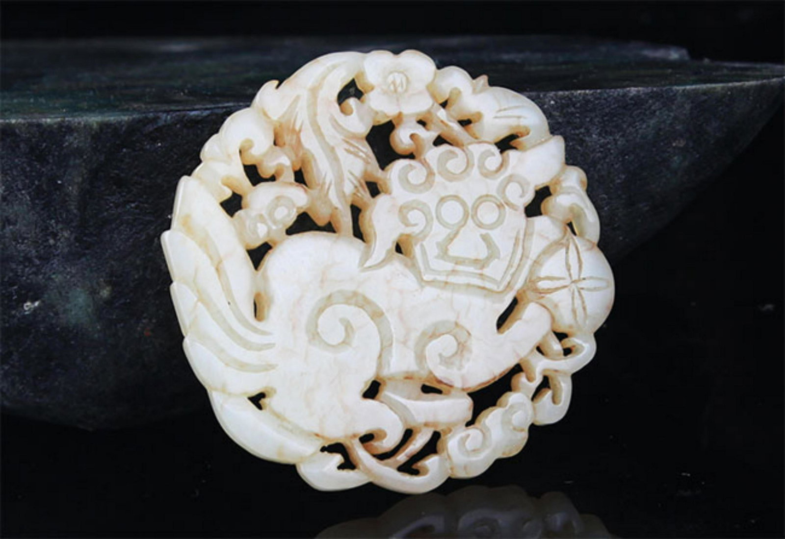 A FINE HE TIAN PALE CELADON JADE PENDANT IN FIGURE OF LION (1 of 3)