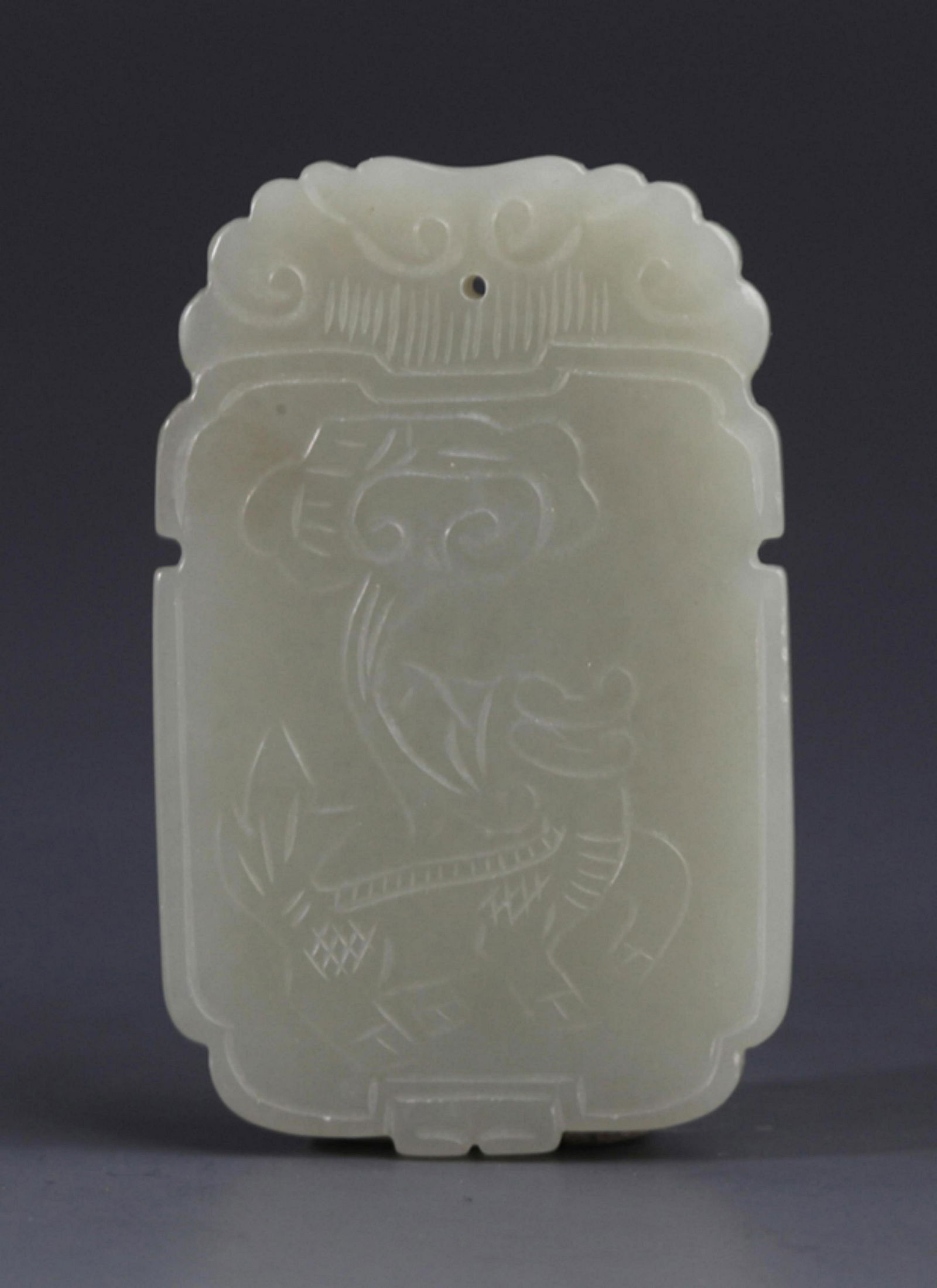A FINELY CARVED PALE CELADON JADE PENDANT PENDANT: 20th Century, Long: 2.28 inch; Width: 1.45 inch