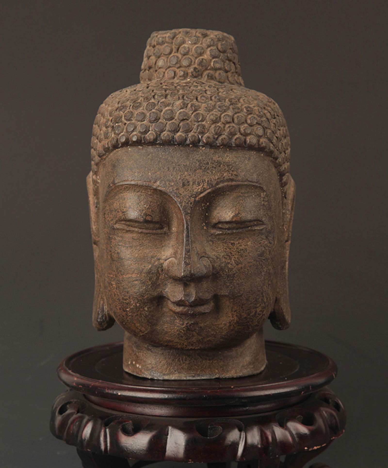 A FINELY CARVED STONE BUDDHA HEAD (1 of 7)