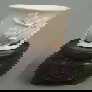 A FINE DEHUA GLAZED AND CARVED WHITE PORCELAIN PLUM BLOSSOM CUP: Qing Dynasty, High:2.4 inch; Diameter: 3.3 inch;