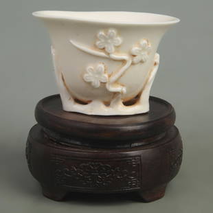 A FINE DEHUA GLAZED AND CARVED WHITE PORCELAIN PLUM BLOSSOM CUP: Qing Dynasty, High:2.4 inch; Diameter: 3.3 inch;