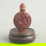 A FINE CARVED LACQUER STORY FIGURE SNUFF BOTTLE