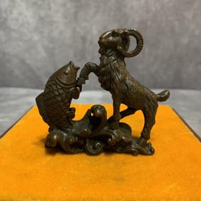 A FINE SMALL GOAT WITH FISH BRONZE STATUE