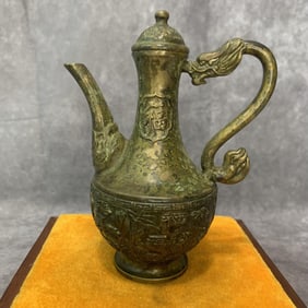 A FINELY CARVED BRONZE EWER