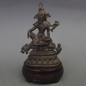 A BINE GILT BRONZE GREEN TARA RIDING A BEAST STATUE