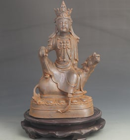 A FINE CAST IRON SEATED GUAN YIN WITH LION STATUE