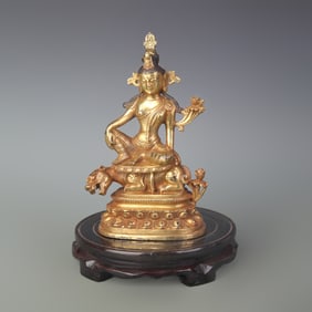 A FINE BRONZE GUANYIN RIDING BEAST STATUE