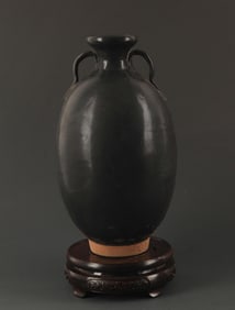 A BLACK GLAZED TWO TILE JAR