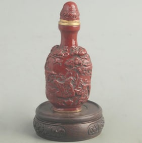 A FINE RED CARVED LACQUER STORY CARVING SNUFF BOTTLE