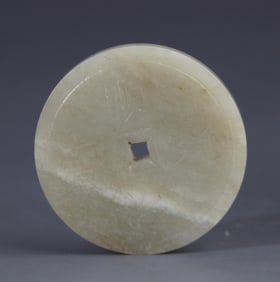 A FINE PALE CELADON JADE COIN FIGURE PENDANT