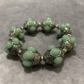 A FINE WHITE BRONZE WITH GEMSTONE BRACELETS