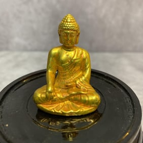 A SMALL BRONZE GILT BUDDHA STATUE
