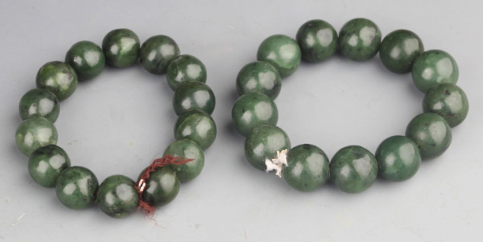 GROUP OF TWO FINE GREEN JADE BRACELETS (1 of 2)