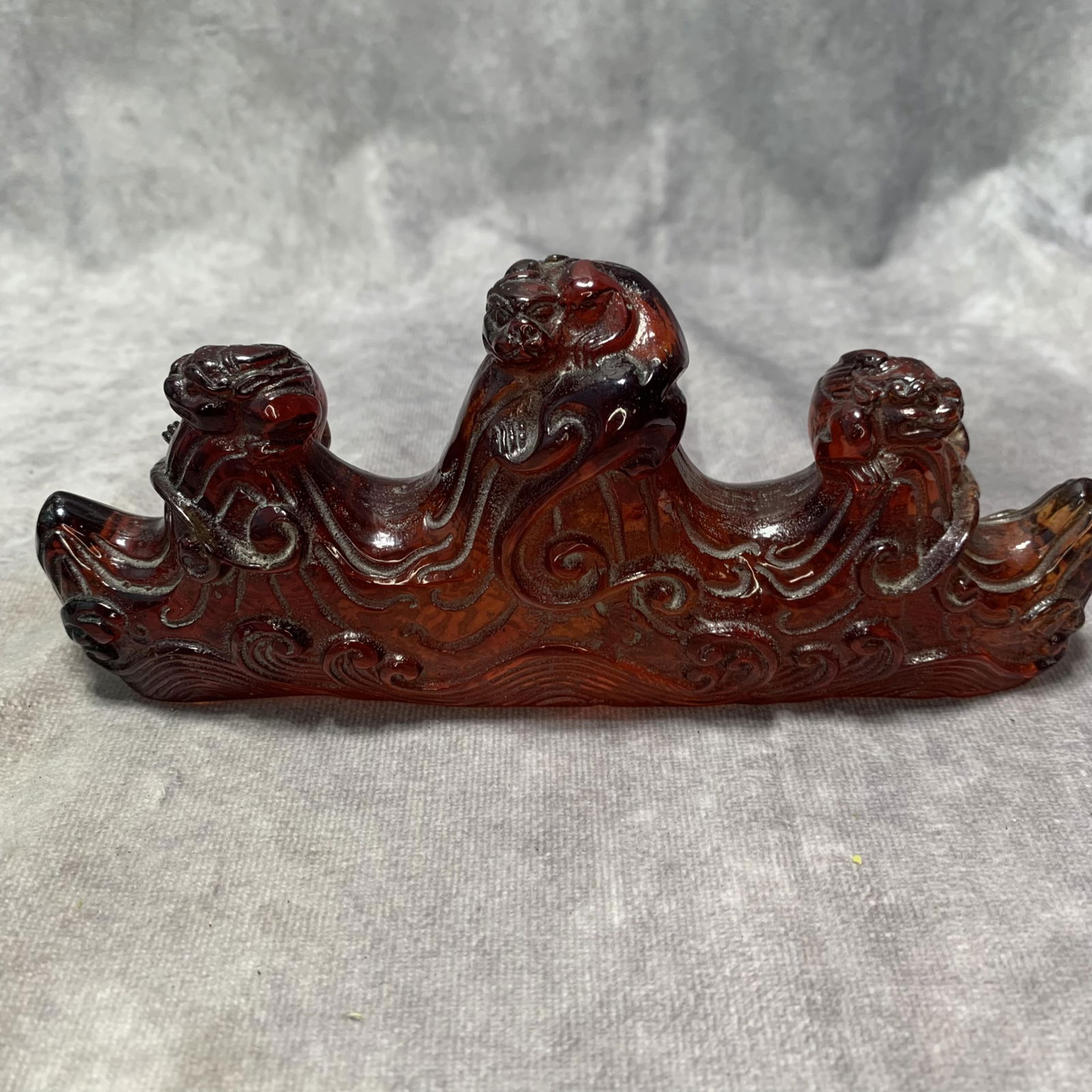A FINE AMBER MADE MOUNTAIN SHAPED BRUSH REST (1 of 6)