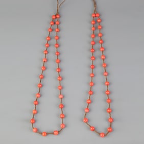 TWO STRINGS OF CORAL BEADS (31 BEADS EACH)