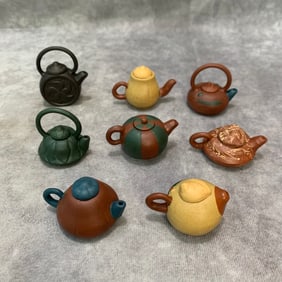 GROUP OF 8 SMALL YI XING ZISHA TEAPOT FIGURE