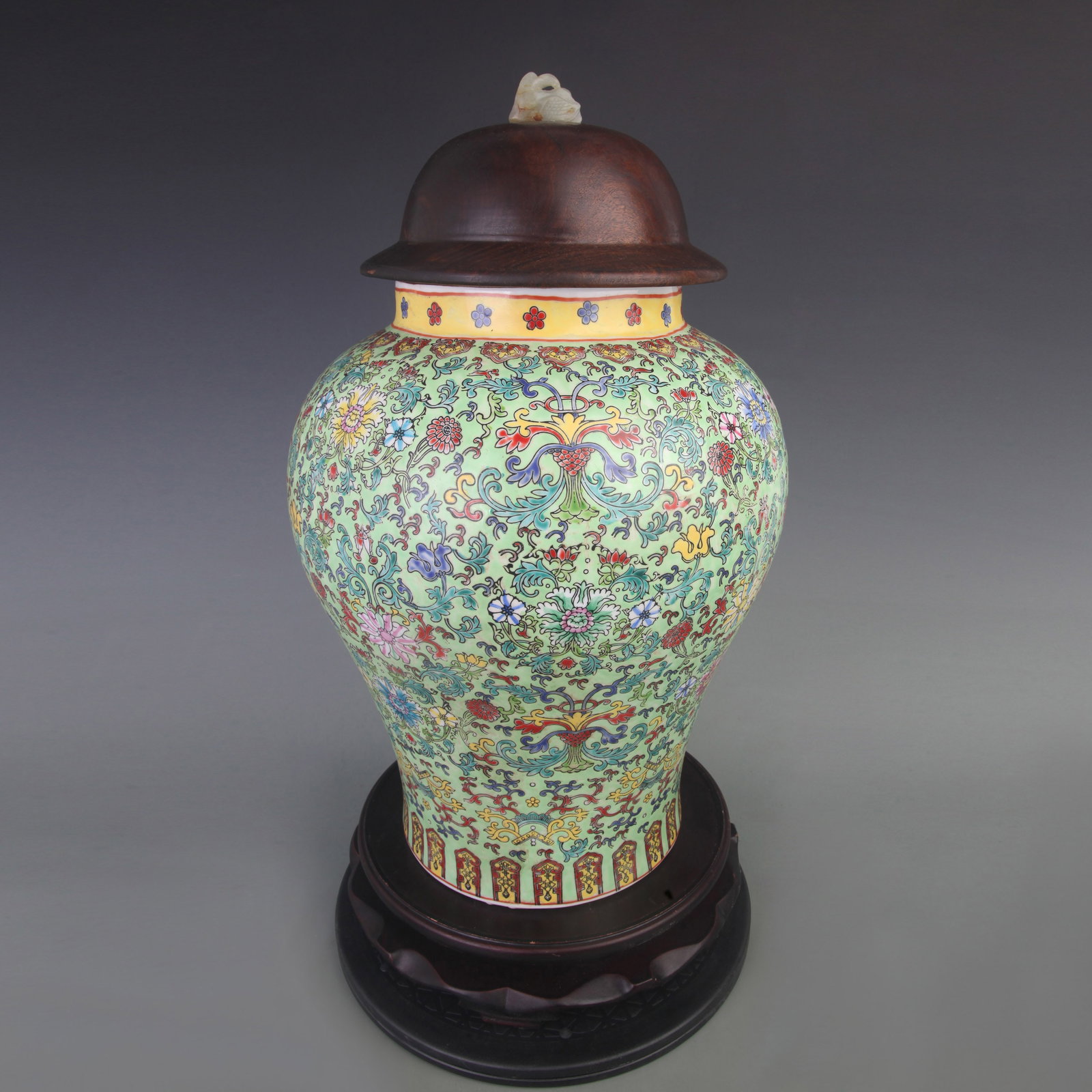 FAMILLE ROSE GREEN GROUND FLORAL GENERAL STYLE VASE WITH REDWOOD LID AND WHITE JADE KNOB: Qing Dynasty; Diameter: 10.0 inch; High: 18.5 inch