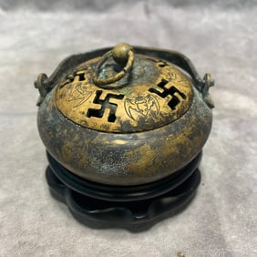 A ROUND BRONZE HAND WARMER