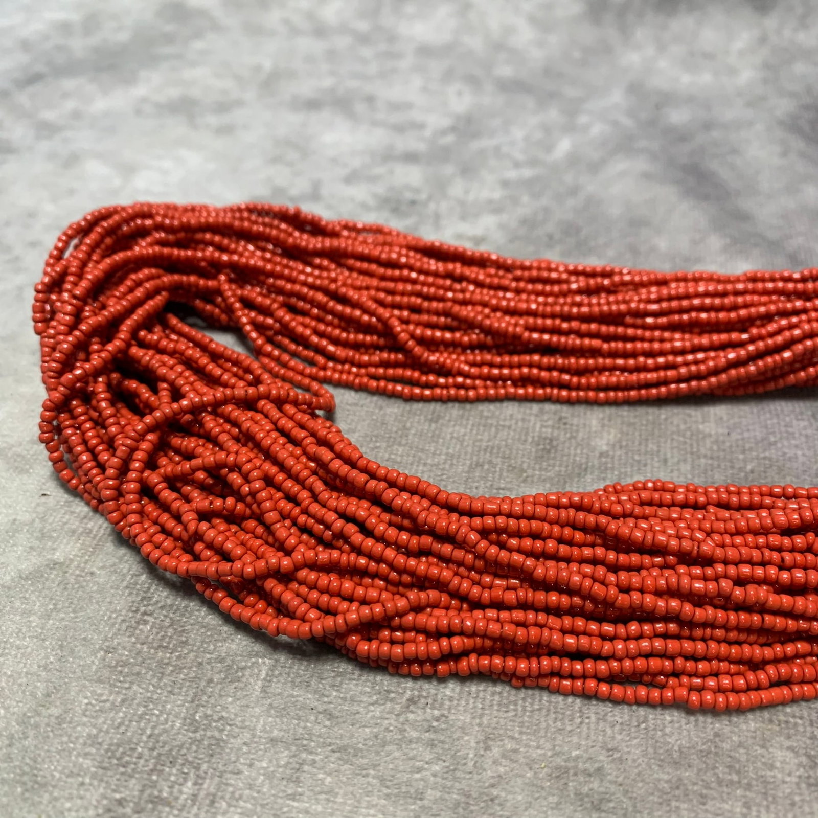 QING DYNASTY TIBETAN CORAL AND YAK BONE 40-STRAND BRAIDED NECKLACE: Modern, Long: 35 inch;
