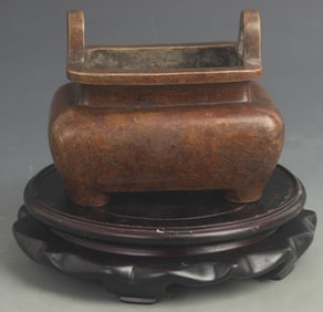 BRONZE INCENSE BURNER WITH FIGURAL SCENES AND TWIN EARS