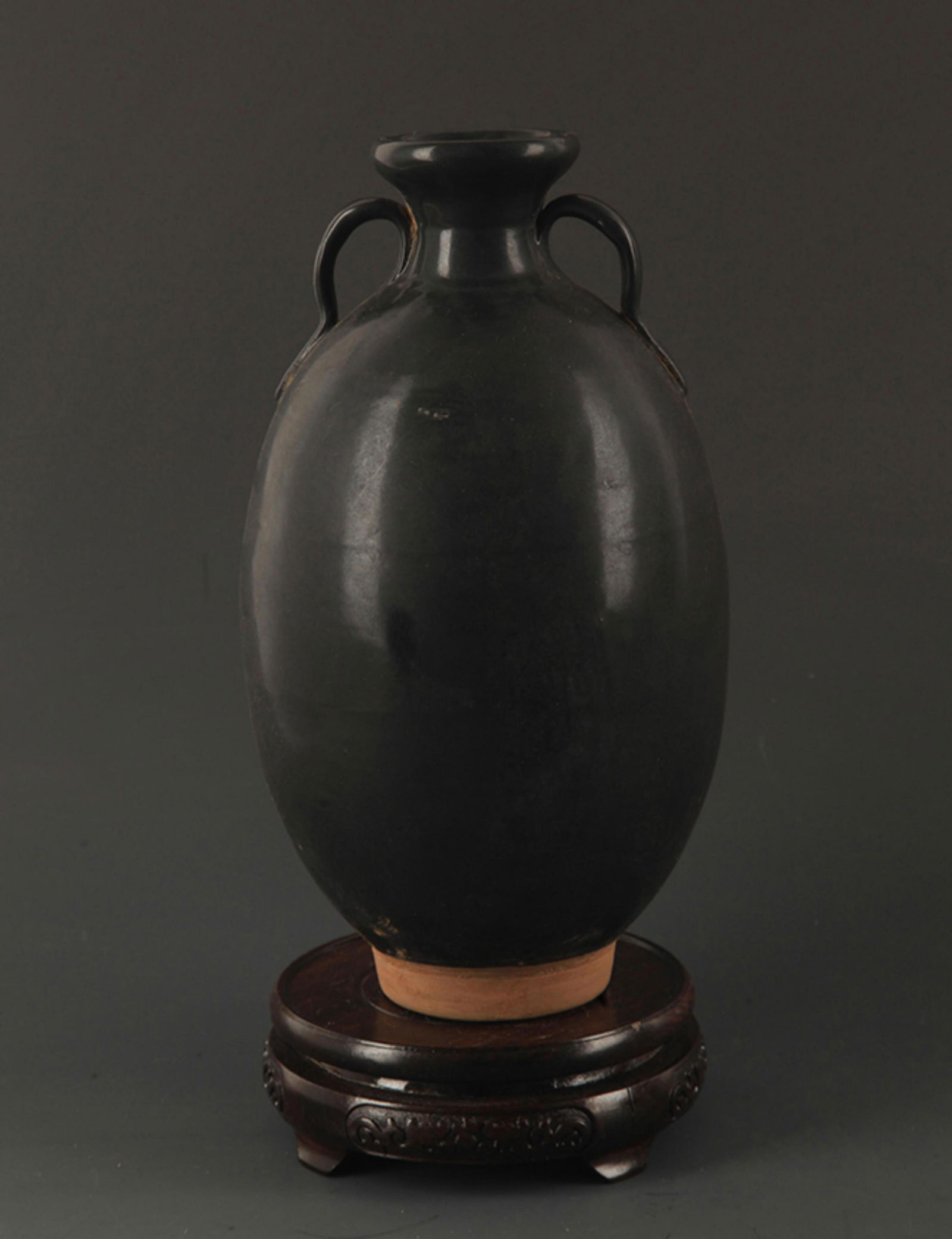 A BLACK GLAZED TWO TILE POTTERY JAR (1 of 6)