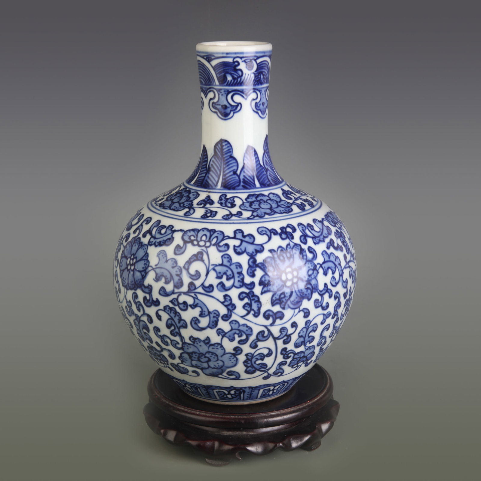BLUE AND WHITE LOTUS SCROLL PATTERN PORCELAIN VASE: Qing Dynasty Qian Long Period; Diameter: 1.9 inch; High: 8.9 inch