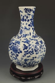 A BLUE AND WHITE BUTTERFLY GLOBULAR SHAPE VASE