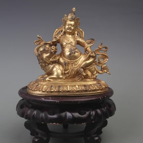 A FINELY CARVED BRONZE HAI BAO TIAN WANG STATUE
