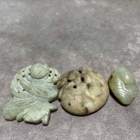 SONG DYNASTY HETIAN JADE FLORAL AND BIRD MOTIF PENDANTS (3 PIECES)