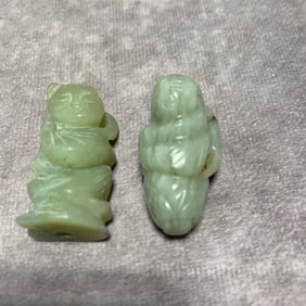 QING DYNASTY HETIAN GREENISH-WHITE JADE FIGURE PENDANTS (2 PIECES)