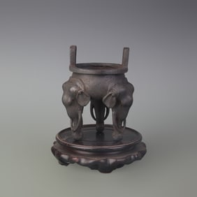 A FINE CAST IRON CENSER WITH ELEPHANT FEET
