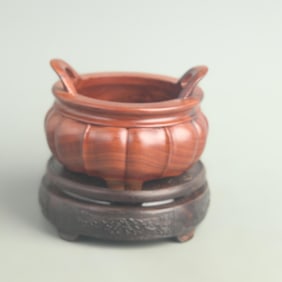 A FINE WOOD MADE INCENSE BURNER