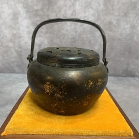 A FINELY CARVED BRONZE HAND WARMER