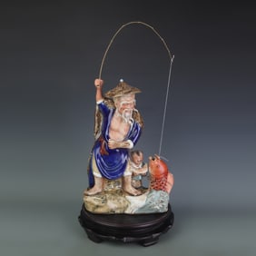 A FINE CERAMIC FISHERMAN ORNAMENT