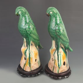PAIR OF GREEN GLAZED POTTERY PARROT ORNAMENTS