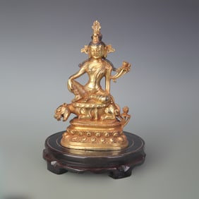 A FIND GILT BRONZE GUANYIN RIDING A BEAST STATUE