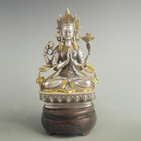 A FINE BRONZE AND SILVER FOUR-ARMED GUANYIN BODHISATTVA STATUE