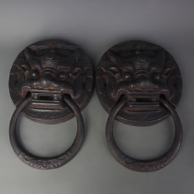 A PAIR OF CAST IRON LION STYLE DOOR RINGS