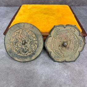 A SMALL BRONZE FINELY CARVED ROUND MIRROR