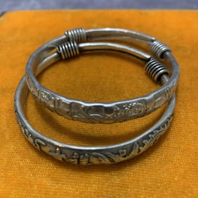 PAIR OF WHITE BRONZE CARVED BRACELETS